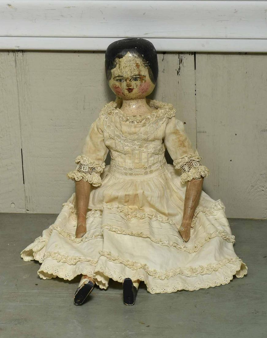 Early Painted Wooden Articulated Doll: Early wooden doll with articulating limbs, in white Victorian dress. 17"H.