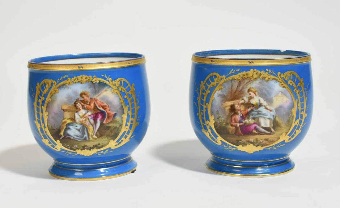 Pair of Sévres Bleu Celeste Jardinieres: Pair of Sévres Bleu Celeste jardineres, with gilding and hand painted courting scenes, 6.5”H x 6.5” dia. 