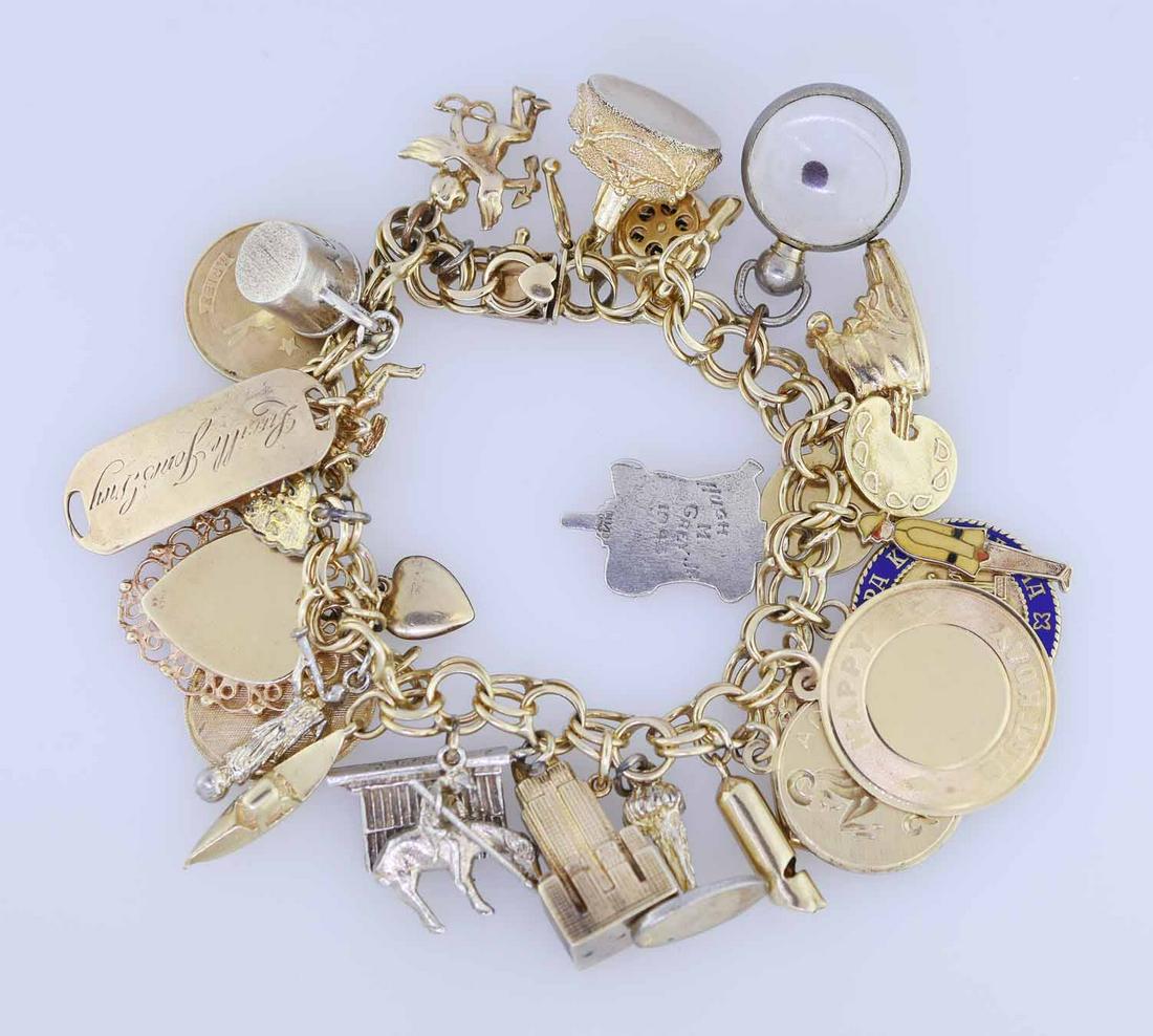14k Gold Charm Bracelet: 14K gold charm bracelet, set with 27 charms, 15 are 13 are 14K gold, 2 are 10k gold the rest gold filled or silver, 7"L approx. 96 grams total.