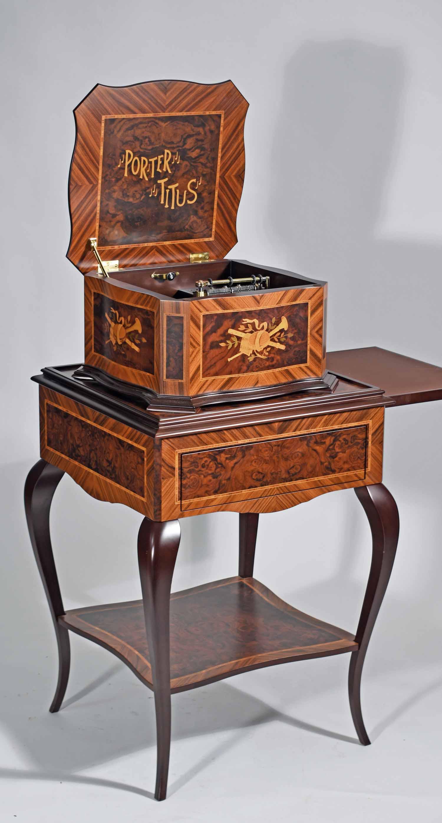 Porter Titus Inlaid Music Box: Porter Titus inlaid music box on stand, with collection of forty discs including Christmas songs, Blue Danube, etc. 18"L x 18"W x 10"D. Overall height 42"H.