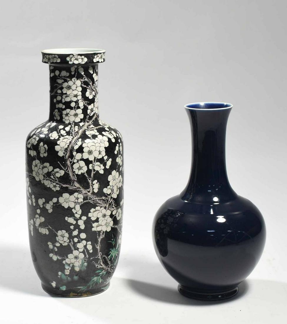 Two Chinese Porcelain Vases: Two Chinese porcelain vases, including a famille noir vase with cherry blossom glaze and blue circular mark on underside, 18”H x 7” dia.; along with a blue monochrome glazed vase with flar