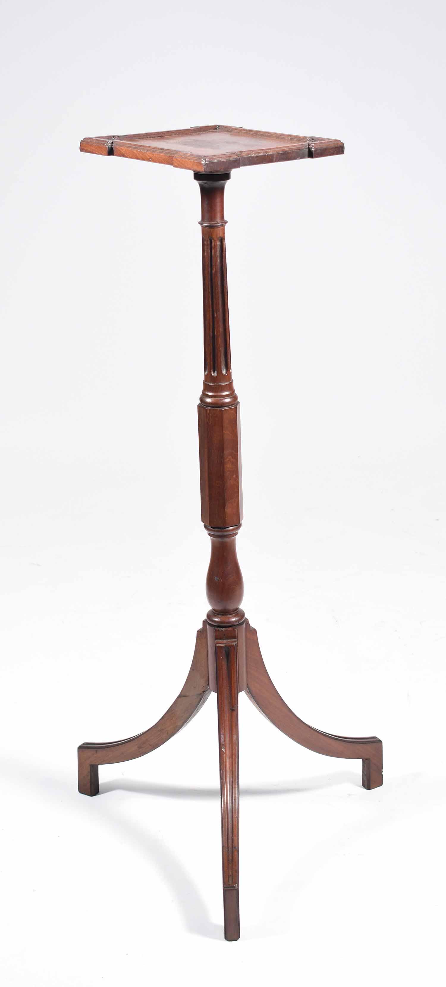19th C. Carved Mahogany Kettle Stand: 9th C. carved mahogany kettle stand, square top with molded edge, a fluted and octagonal pedestal, downward sloping Classical legs, 36”H x 8.5” square.