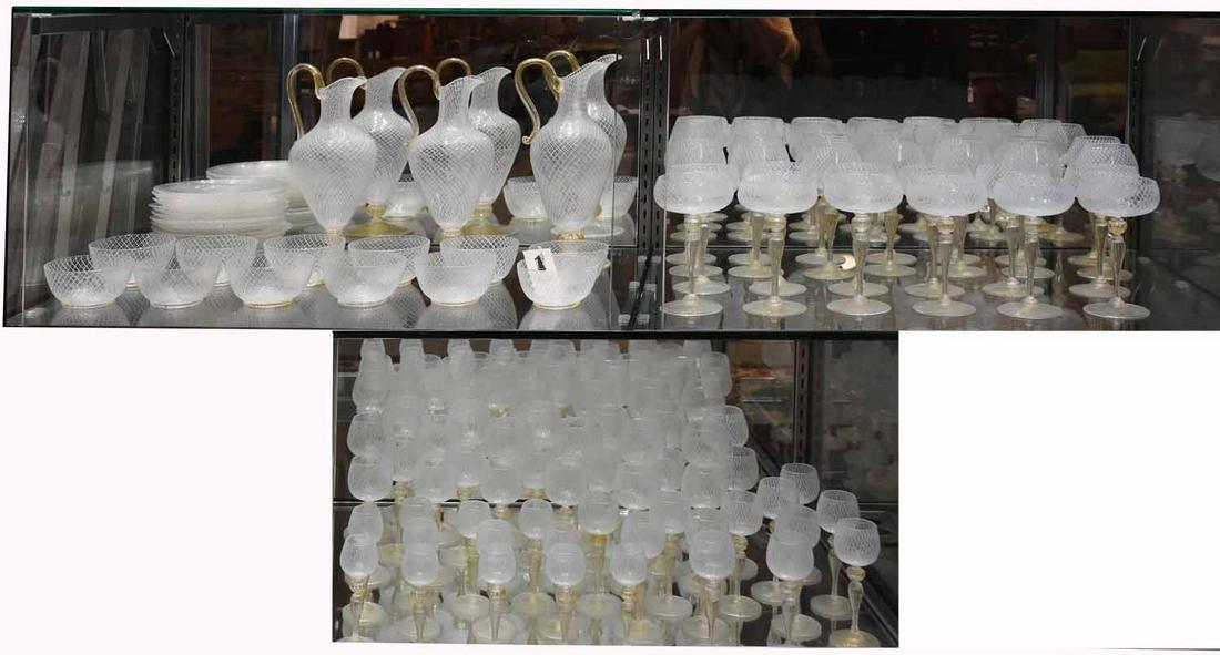 Large Collection of Venetian Glassware: Large collection of Murano “Reticulo Filigrana” glassware, white with gold flecking, including three wine pitchers 12-12.5”H; 12 plates 5.5” dia., 12 small bowls, 14 large wine