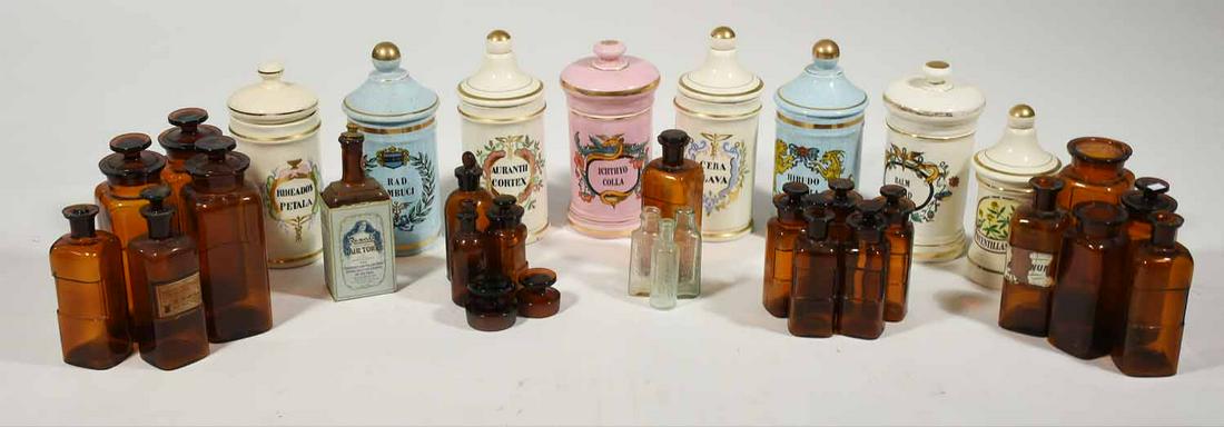 Assortment of 31 apothecary jars: 31 assorted glass and porcelain apothecary jars, many with labels and names, 4.5” - 11.5” H 