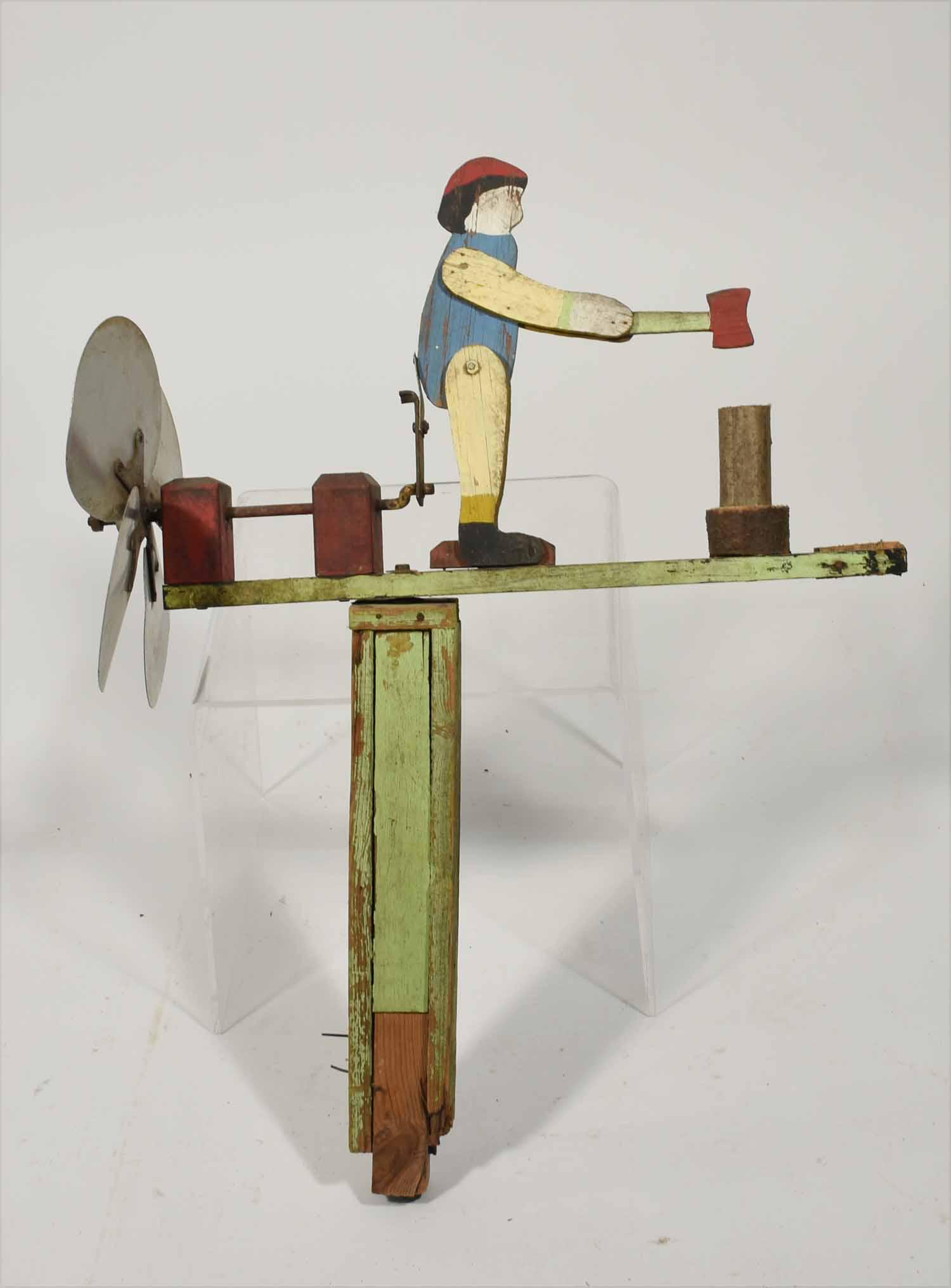 Folk art wood chopper whirligig: Folky wood splitting articulated whirligig in turquoise, blue, red and yellow paint decoration, 29” X 21”