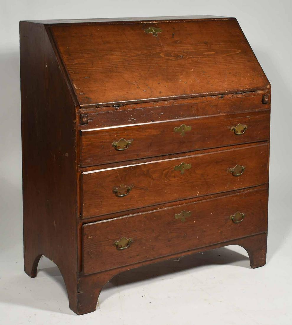 Antique pine slant top desk: 19th C. country pine slant top desk with three case drawers, fitted interior in an old surface on a cut out base, 36 " x H 43 1/2 " x D 19 "