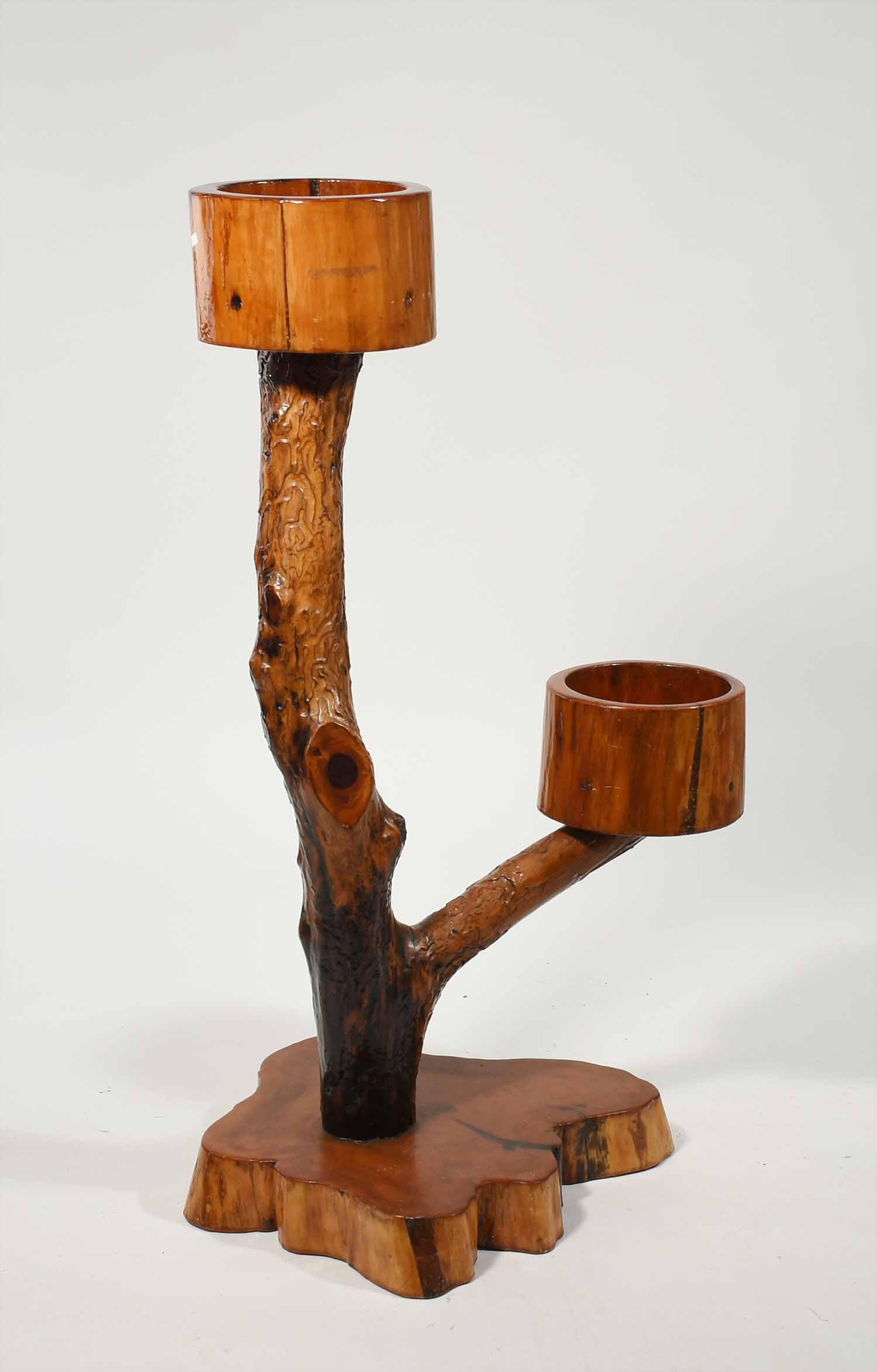 Adirondack planter: Adirondack style planter, with 2 tree limb arms supporting 2 round wood cups 9.5"D on wood slab base, 46"H x 25"W arm to arm