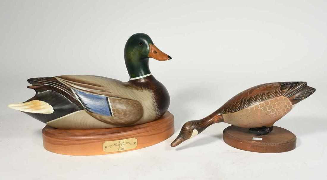 2 carved wooden decoys inc. Ducks Unlimited: Two carved wooden decoys on stands, including one Ducks Unlimited, 12" and 14"L.