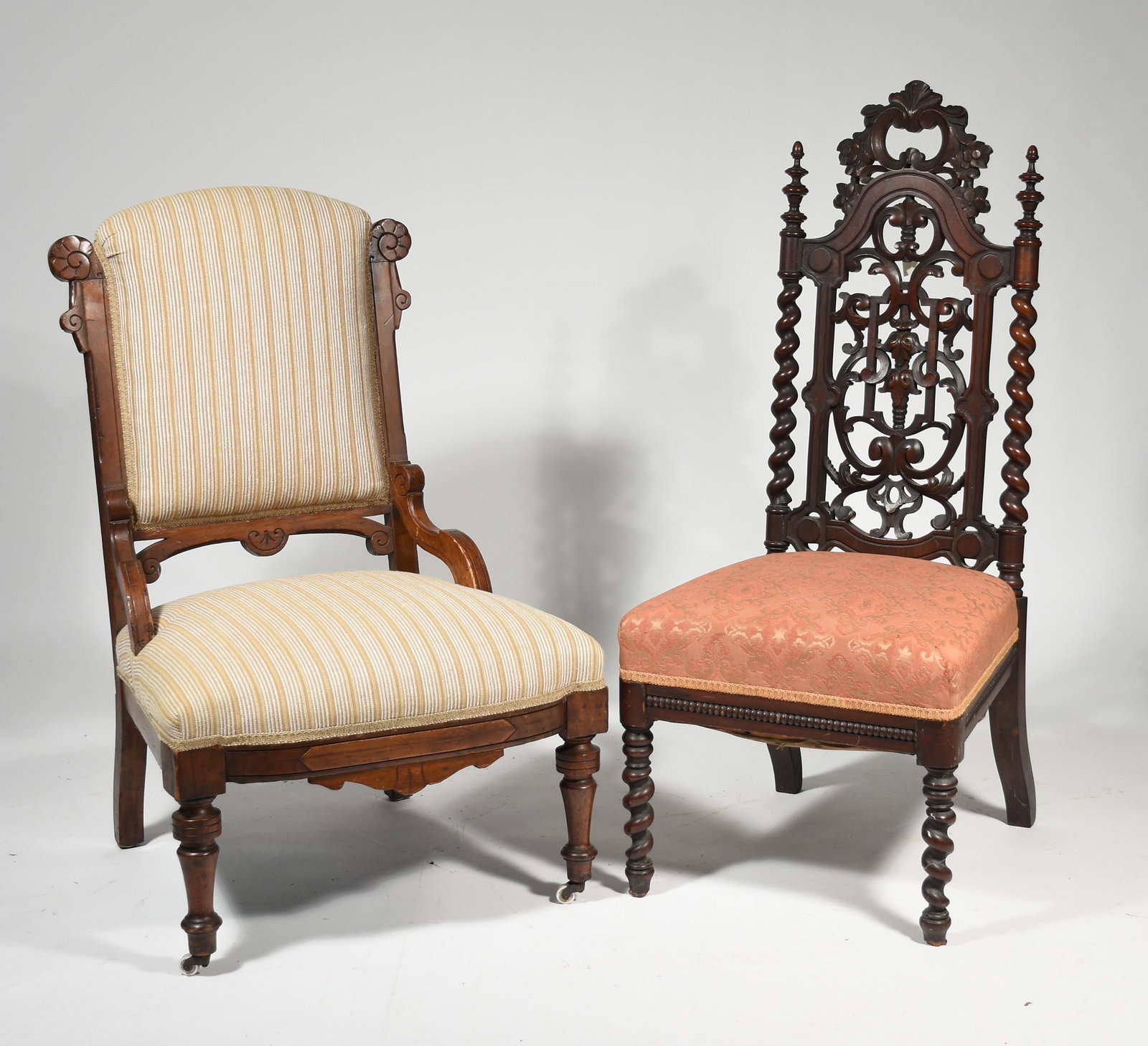 Two 19th C. carved chairs: 19th. C. Carved walnut side chair with through carved and barley twist back, 42.5” H. Along with a Victorian walnut hip armed parlor chair 36" H.