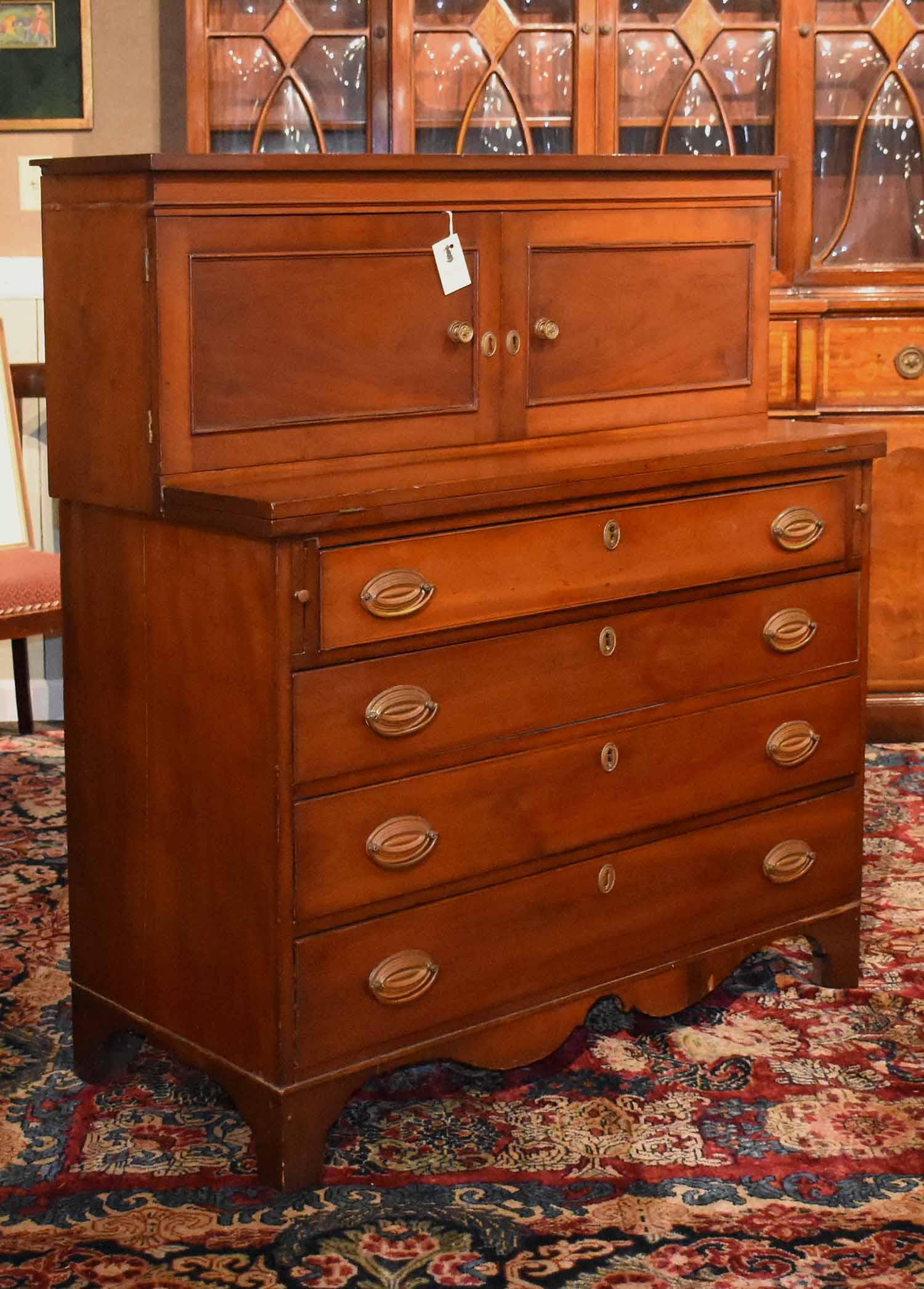 19th C. Cherry Federal Secretary: 19th C. American cherry two-part ladies Federal secretary with double doors above case of four drawers below on cut-out base and apron, 40” W X 46” H X 19” D 