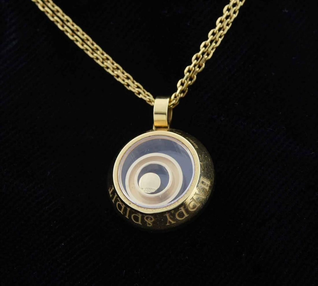 18kt yellow gold signed Chopard "Happy Spirit" floating: 18kt yellow gold signed Chopard "Happy Spirit" floating ring necklace set with approx. .09 ct. round brilliant cut diamond (G-VS), 17 mm round pendant, 16 in. long double chain, 14 grams. 