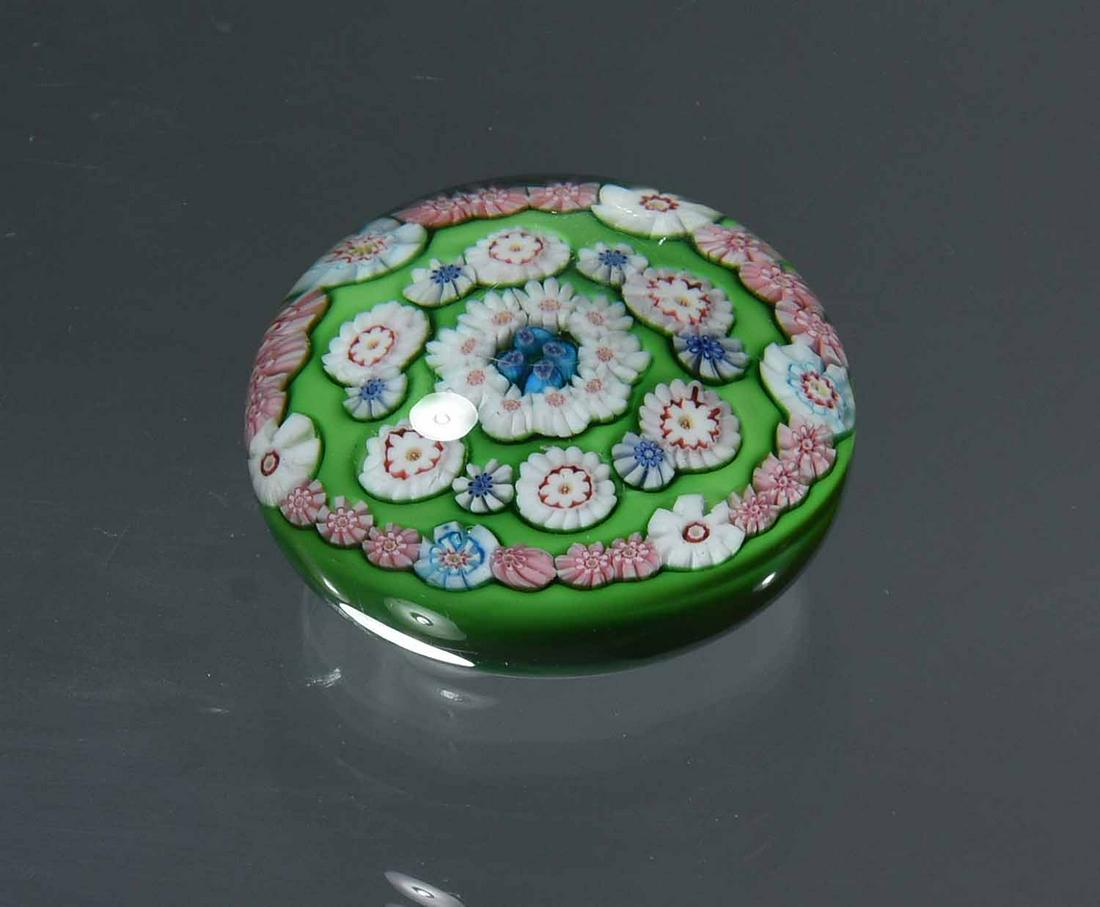 Clichy Spaced Concentric Millefiori Paperweight: Clichy spaced concentric millefiori paperweight on green ground, height 2", 3 1/8” dia.