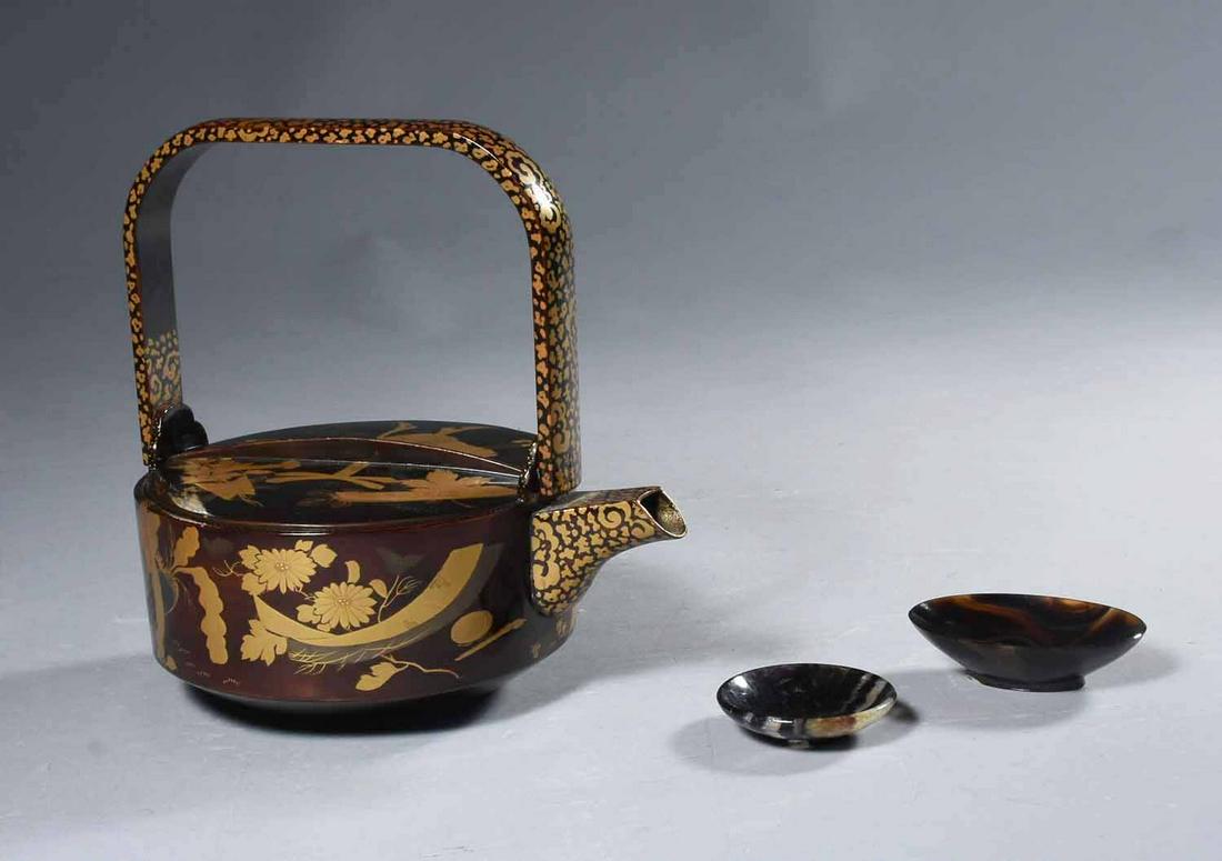 Japanese Teapot W/ Two Hardstone Dishes: Japanese ceremonial lacquer decorated handled teapot together with two Chinese hardstone dishes. The teapot with gilt decoration, height 7 1/2", width 5 3/4", length 7 3/4"; the small dishes possibly 