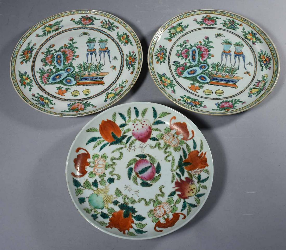 Lot of Three Chinese Plates: Chinese porcelain enamel "Bat and Peach Blossom" dish together with a pair of Chinese Famille Verte enamel 'Scholar's Treasures' plates. Signed on top near center and on reverse with four character ma