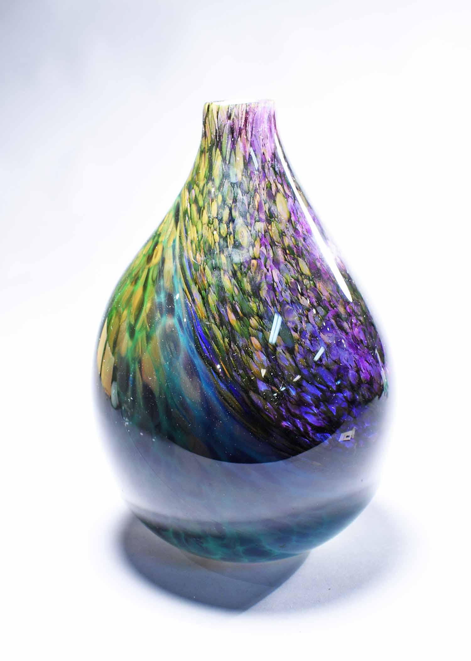 M. Vineyard Art Glass Vase: Martha's Vineyard Glassworks Art Glass Vase, circa 1995. Height 11", diameter 8". Hand-blown with scaled and swirled amethyst and green pattern. Note that the vase appears much darker under natural li
