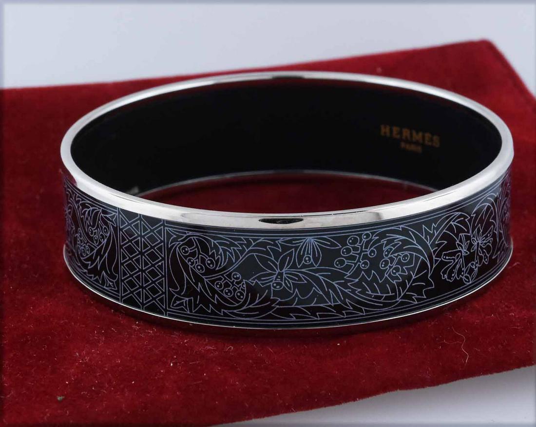 Hermes bangle bracelet: Hermes bangle bracelet, black with white floral detail, signed inside band Hermes Paris, 2.75"D.