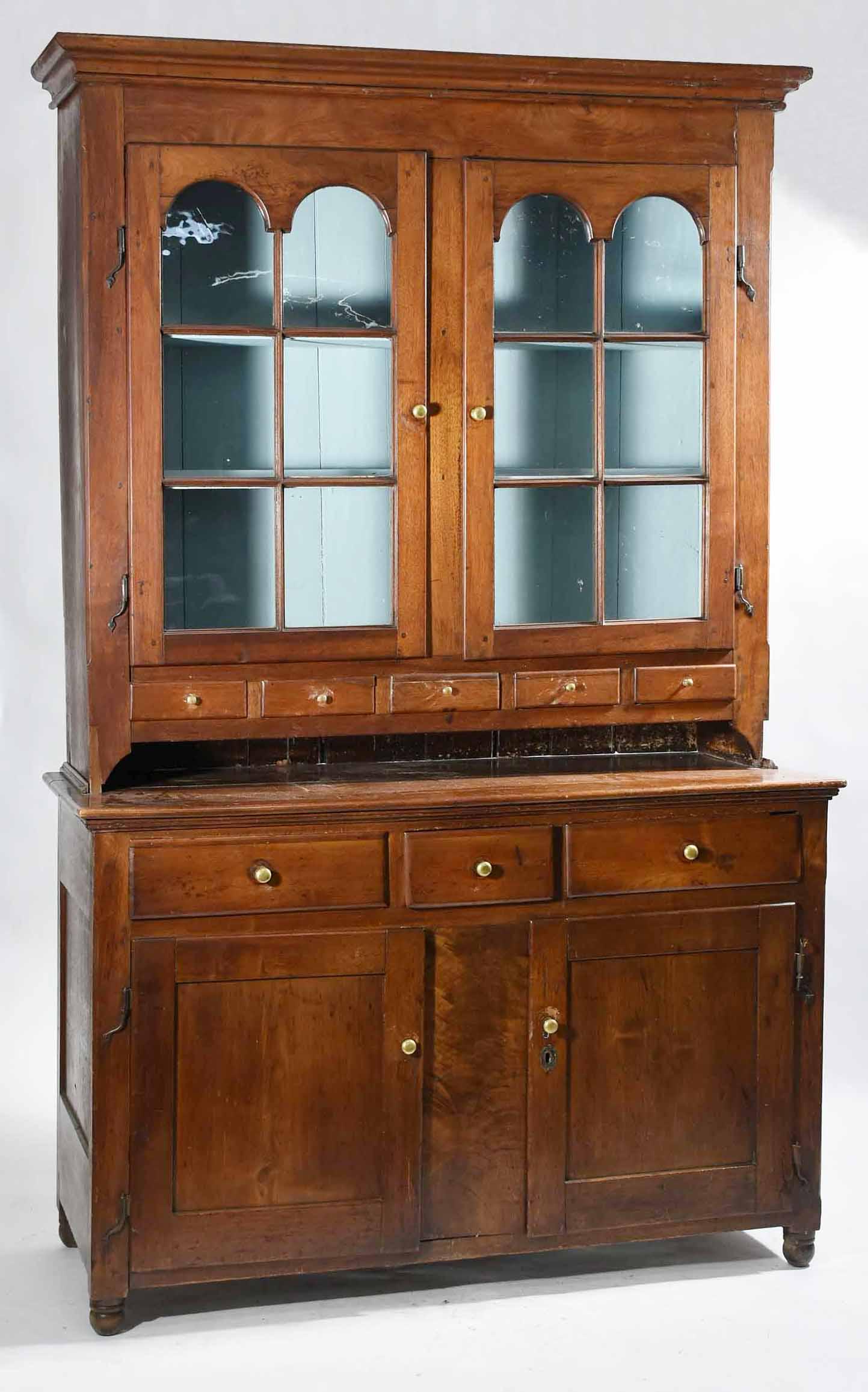 18TH C. PA WALNUT SET-BACK DUTCH CUPBOARD: Two-parts with upper section having two glass doors over five small drawers. Lower section with three drawers over two blind panel doors on turned feet. Old iron hinges, drawers and doors set with bra