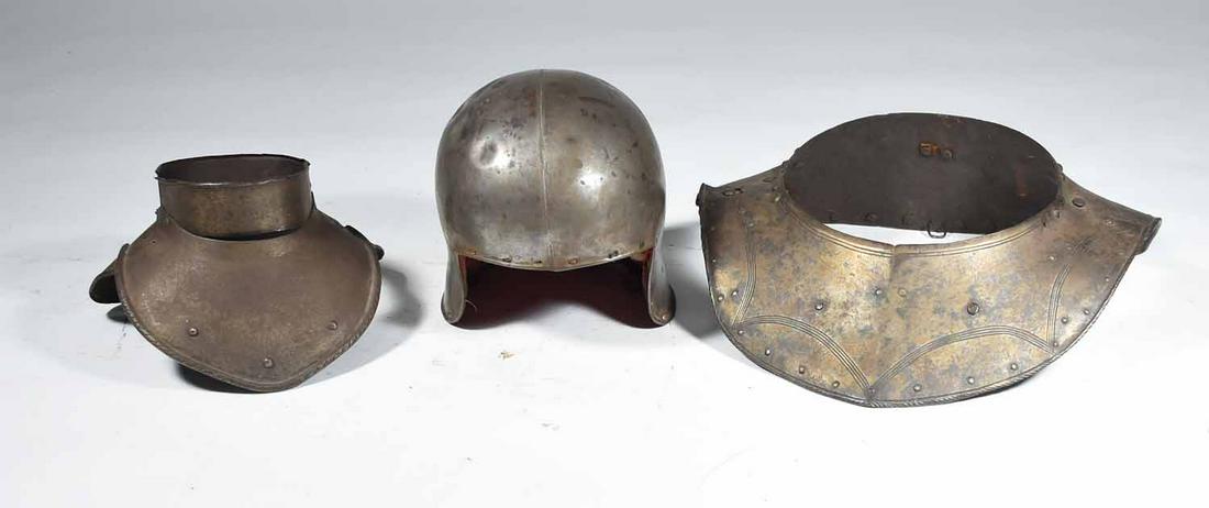 THREE PIECES OF EARLY ARMOR: Early steel breast plate and helmet along with small child’s size example. Larger breastplate with tolled recessed ribbing and rolled edges 15 1/2” W x 14” D; small example with atta
