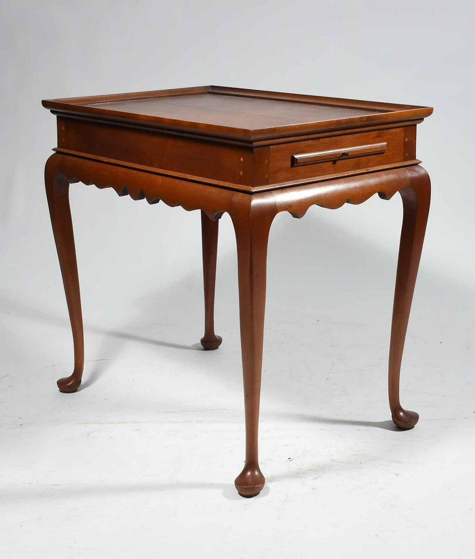 ELDRED WHEELER CHERRY TEA TABLE: ELDRED WHEELER CHERRY TEA TABLE. Labeled and branded Queen Anne style tea table with pull-out candle slides and tray top. Shaped apron above cabriole legs on pad feet. 26.75” H x 28” W x 1