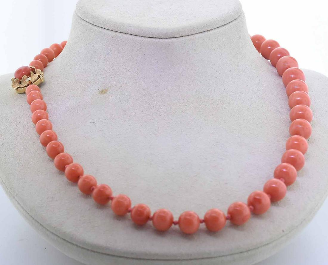 SALMON CORAL BEADED NECKLACE W/ 14K GOLD CLASP: SALMON CORAL BEADED NECKLACE W/ 14K GOLD CLASP. They are mostly an even medium dark slightly reddish orange in color (or salmon) with some light mottling, lightly blemished. The beads range from 7 