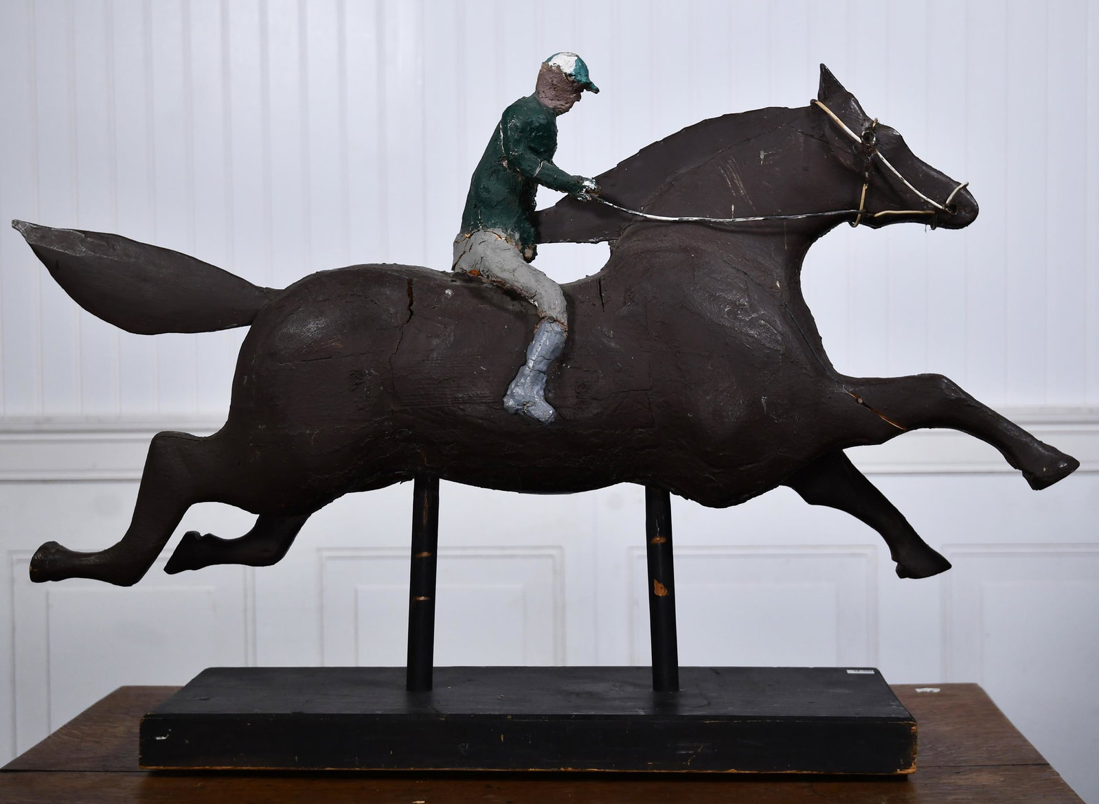 20TH C. HORSE AND JOCKEY FOLK ART SCULPTURE.: Hand painted jointed wood and gesso folk art sculpture with plastic covered cable as bridle.20”H x 29”W x 7.5”D.
