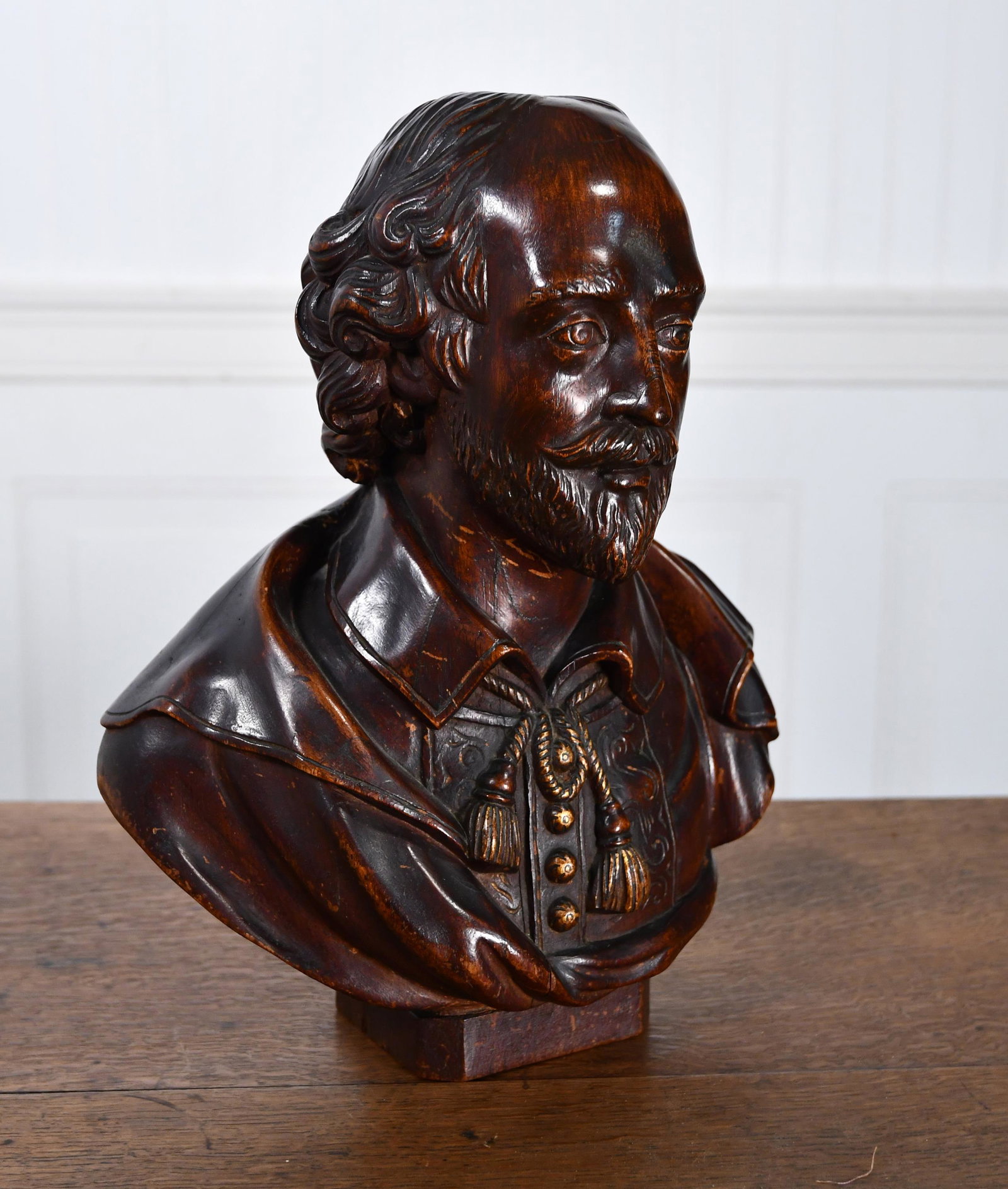 CARVED WOODEN BUST OF SHAKESPEARE.: Unsigned nicely carved bust with diminutive wooden base. Bust and base appear to be carved out of more than one piece of wood. Nice dark finish.13.5”H x 10.5”W x 5.75”D.