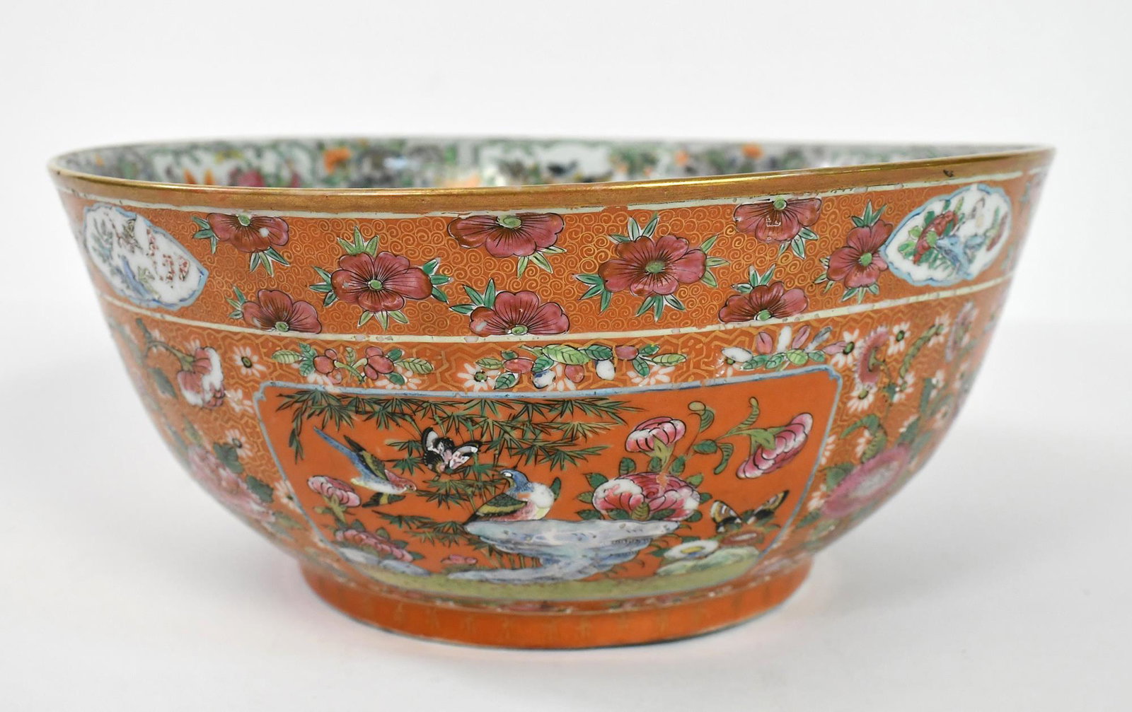 CORAL GROUND CHINESE FAMILLE ROSE BOWL.: Impressively large and detailed Chinese porcelain bowl depicting roses, butterflies, birds, other flora in a sanctuary setting. Clear signature chop on underneath of bowl. 5.5”H x 12.5” di