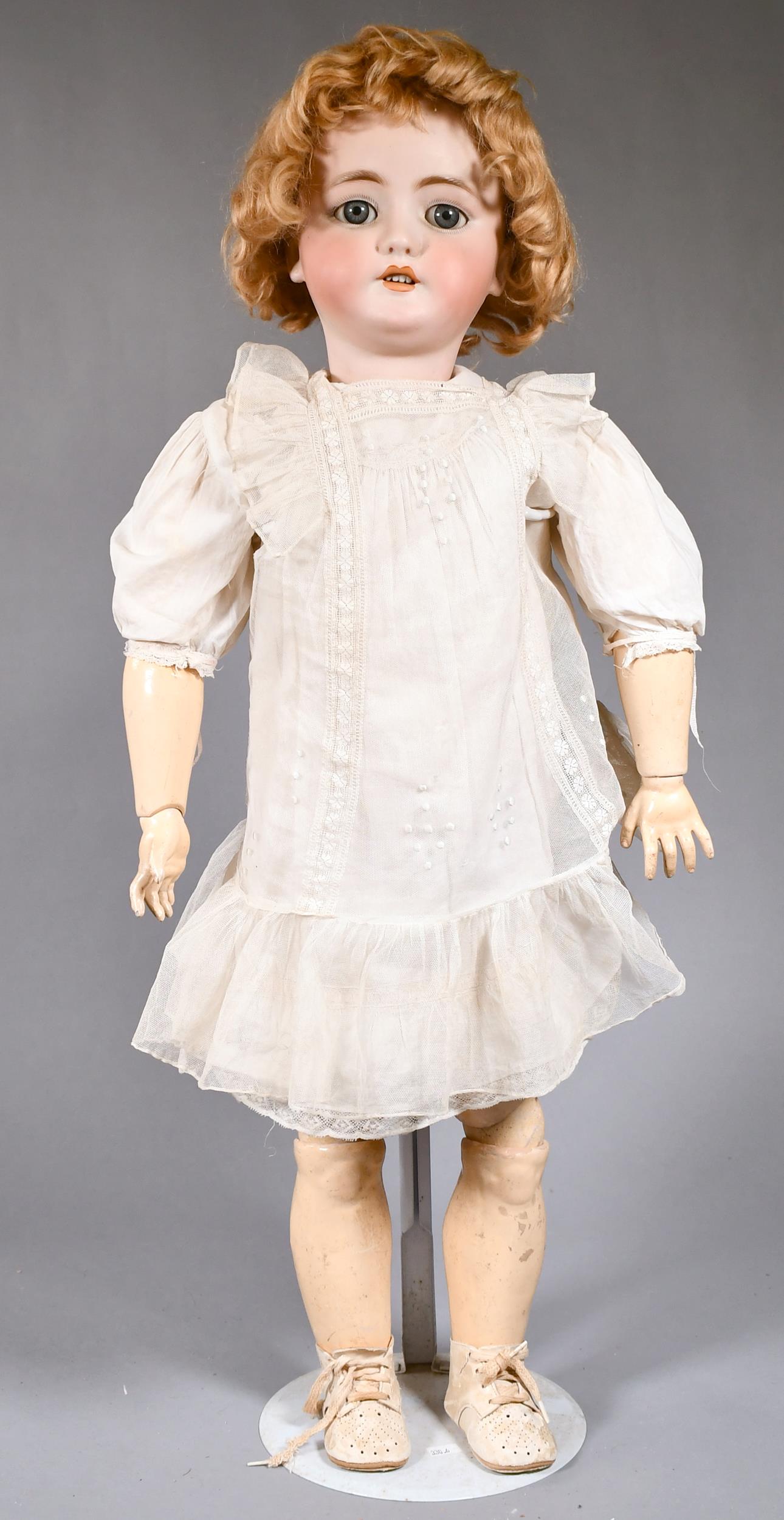 LARGE CM BERGMANN, SIMON AND HALBIG BISQUE DOLL.: Featuring sleep eyes and open mouth with exposed teeth. Doll is in period clothes and period footwear. Marked on the back of head with #14 1/2. 32”H.