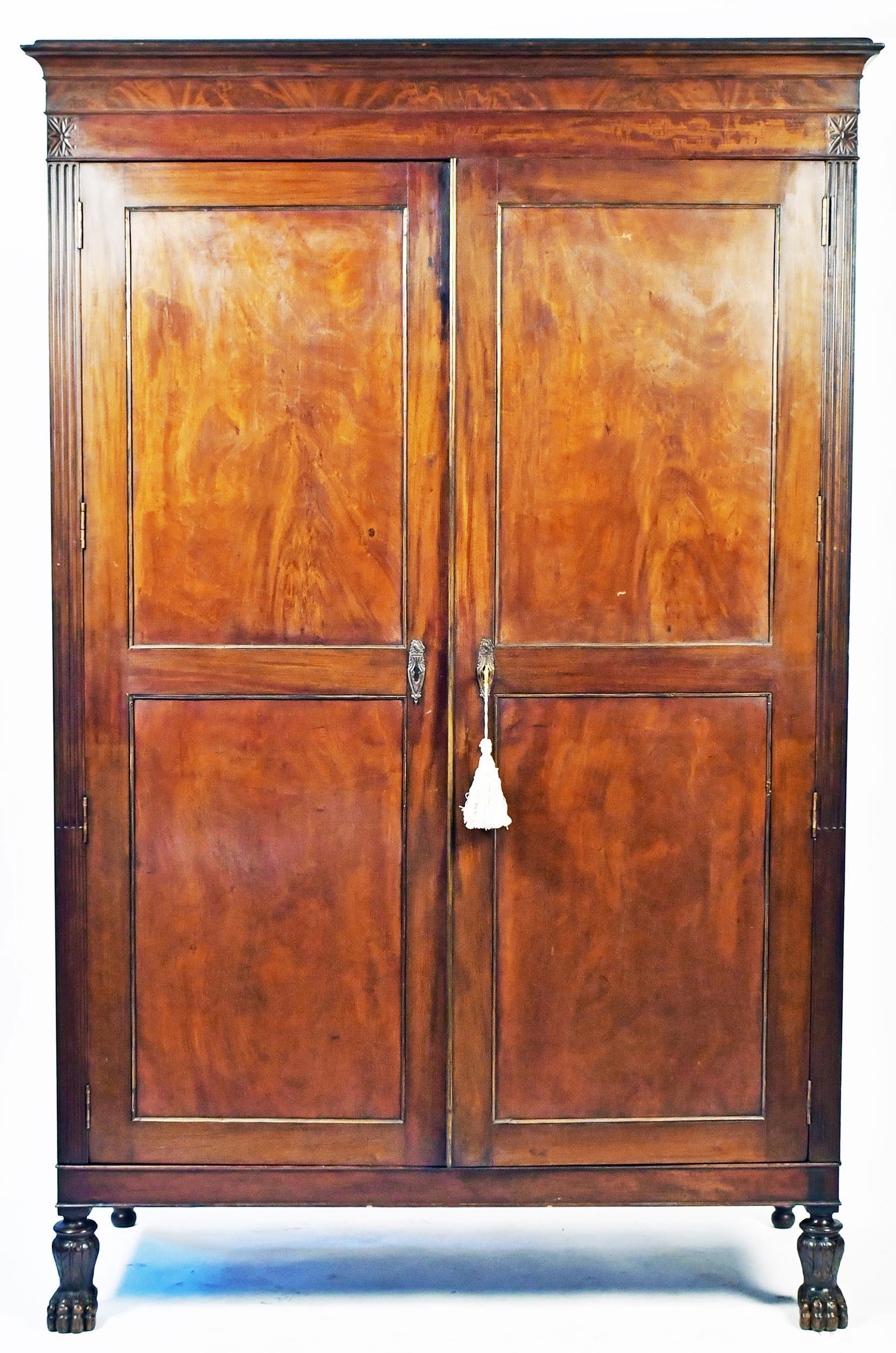 IMPORTANT CLASSICAL NY PRESS CUPBOARD CA. 1815-1820: Likely the work shop of either Charles Honore Lannuier or Duncan Phyfe, in rich mahogany with a molded cornice top, two panel doors flanked by stop fluted stiles with carved hairy paw feet, interior w