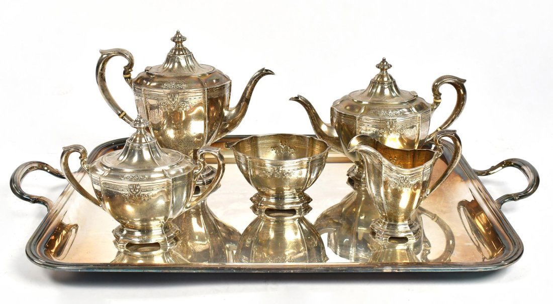 SHREVE & CO. STERLING SILVER TEA SET.: Five piece tea set with floral decoration. Including: coffee pot with bone handle insulators 9”H x 10.5”W, tea pot with bone handle insulators 8”H x 10.5”W, lidded sugar bowl 7