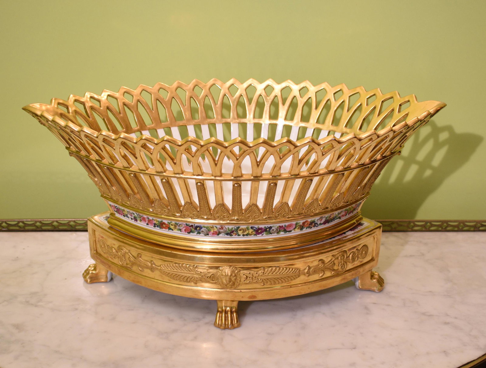 19TH C. FRENCH FRUIT BASKET.: Likely old Paris, two part, highly gilt decorated oval, reticulated basket with raised gold gilt fleur-de-lis, on a platform stand with raised gold gilt lions and harps, on animal paw feet. Signed on