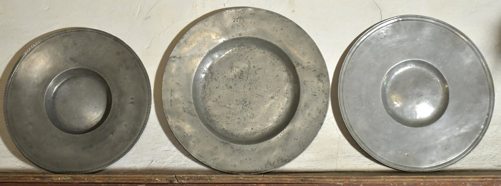 THREE EARLY WIDE RIM PEWTER CHARGERS. (1 of 9)