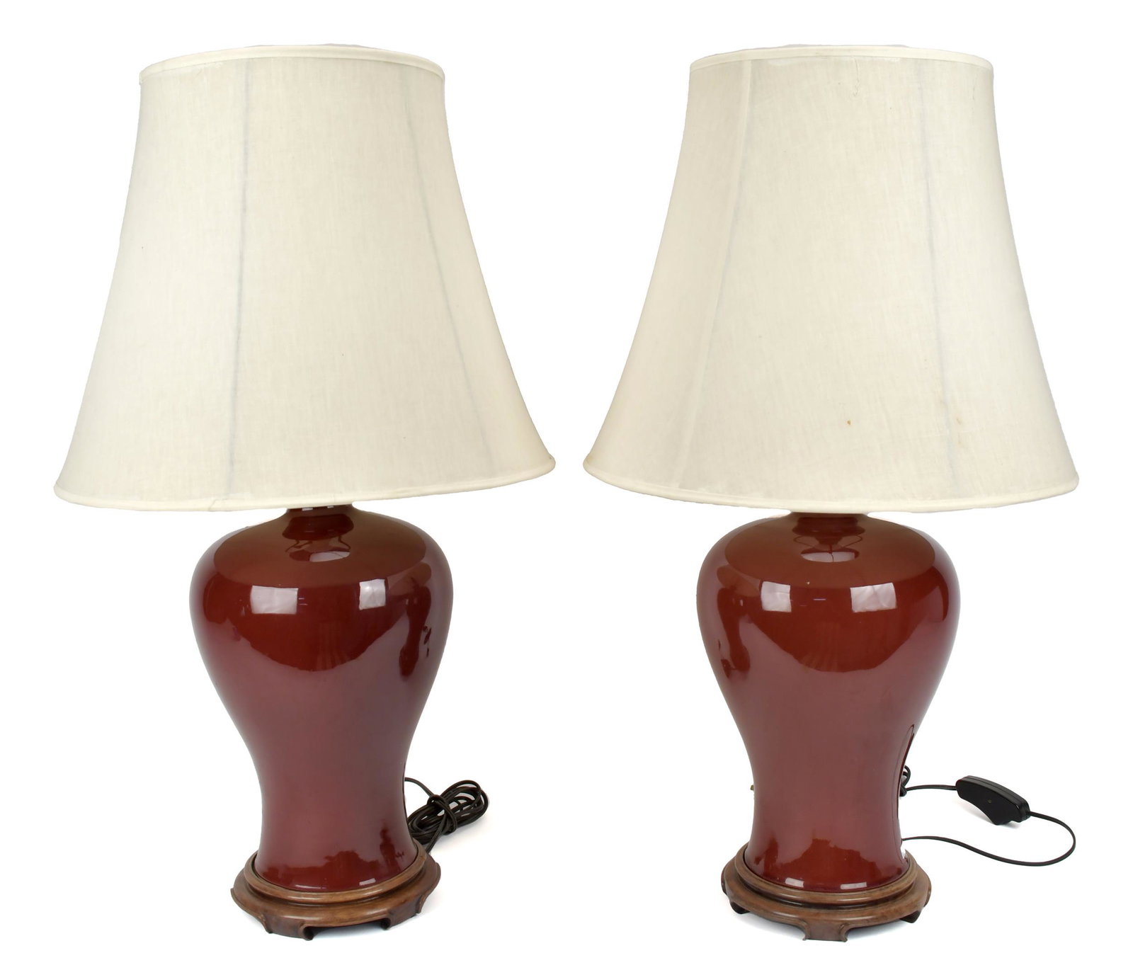 PAIR OF CHINESE OXBLOOD PORCELAIN LAMPS.: Early 20th C. baluster form oxblood glazed porcelain lamps, Porcelain 14.5”H x 31” overall.
