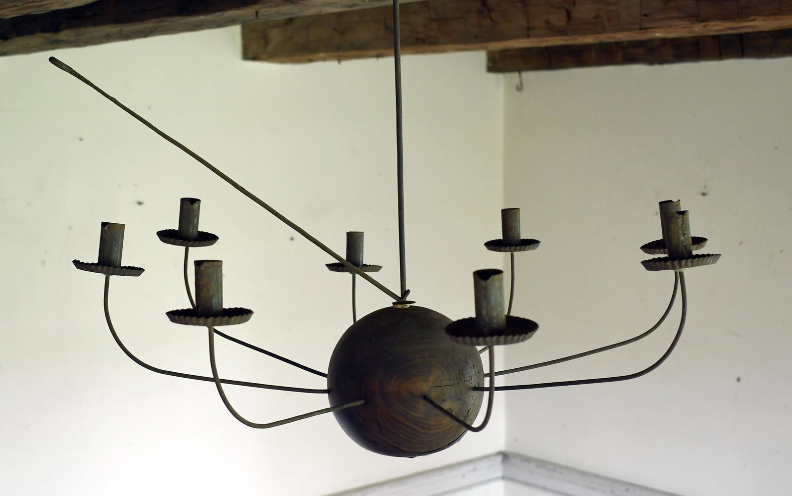 COUNTRY WOODEN WIRE CHANDELIER.: Iron rod supporting a spherical wooden base with six wire candle arms, with crimped tin bobeches and candle cups, 21”H x 29” dia.