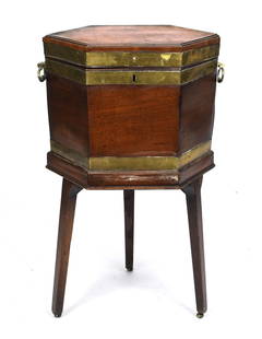 ANTIQUE ENGLISH GEORGE III CELLARETTE.: Ca. 1790-1800 mahogany brass bound hexagonal cellarette, with a hinged lift top, and a section lined interior for bottles, on three Hepplewhite tapered legs, early brass handles, 29”H x 18”