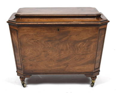 19TH C. ENGLISH REGENCY CELLARETTE.: Ca. 1820 fine English Regency mahogany sarcophagus form cellarette/wine cooler, with a hinged lift top, and a six section interior for bottles, and two fine fire gilt brass lion’s head handles,