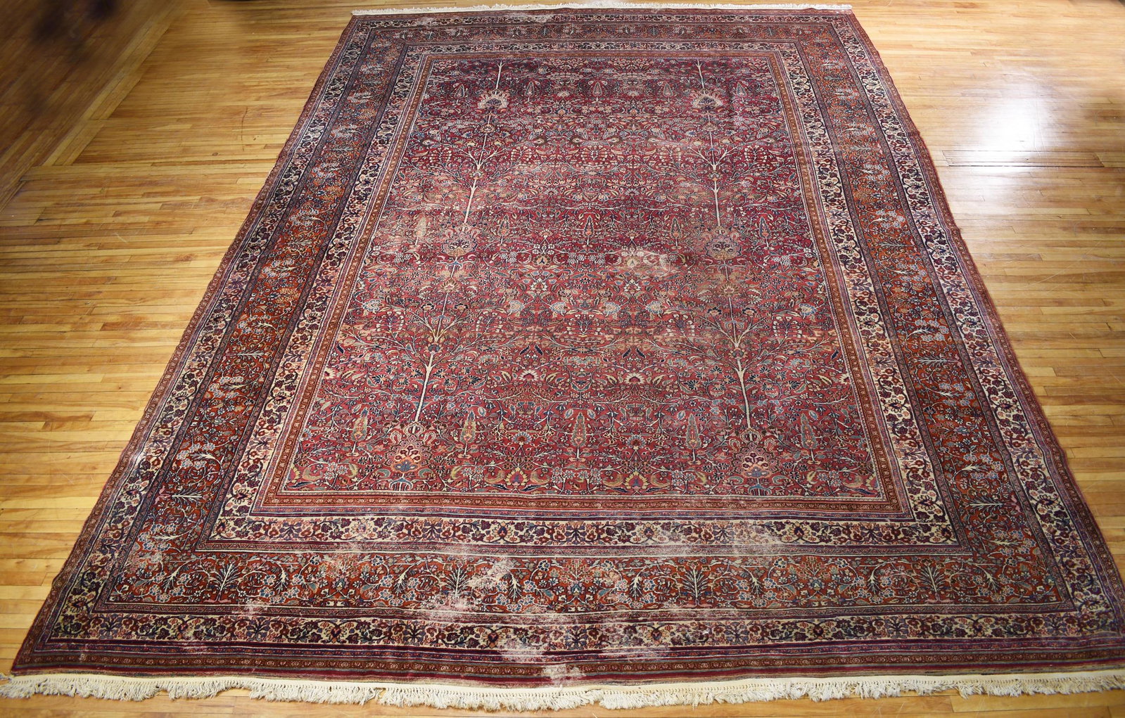 ANTIQUE LARGE ROOM SIZE MESHED ORIENTAL RUG.: Antique large room size Meshed Oriental rug, with a complex central field depicting garden/tree of life scene, surrounded by complex multi banded border, rich dark purple/maroon ground, highlighted wi