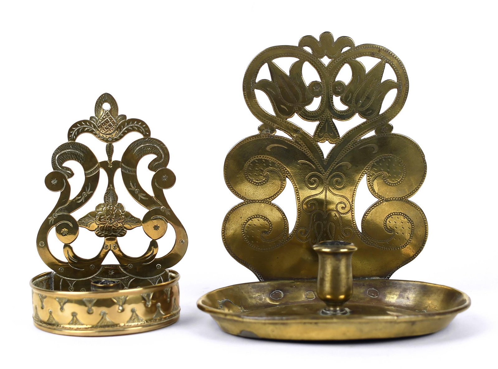 TWO CA. 1700 DUTCH BRASS CANDLE SCONCES,: Two fine early 18th C. Dutch brass candle sconces, with pierced back plates and saucer bases, 7” and 9”H.