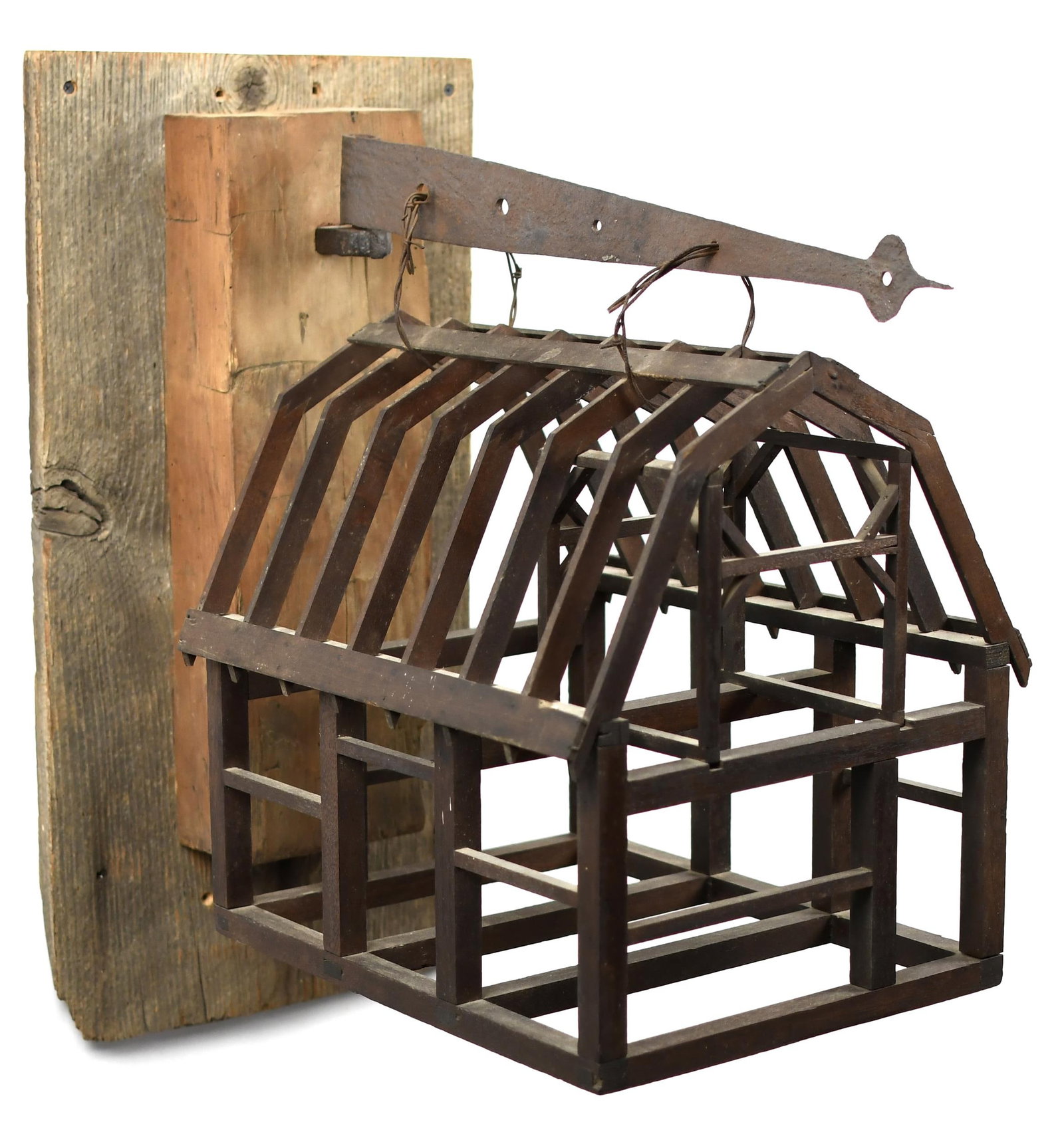 ANTIQUE BARN FRAME TRADE SIGN.: A late 19th C., barn builder/framer trade sign, mounts to a wall on a barn board and beam bracket with early iron hinge. Barn 18”H x 17”W x 14”D., wall bracket 26.5”H x 17.5&rd