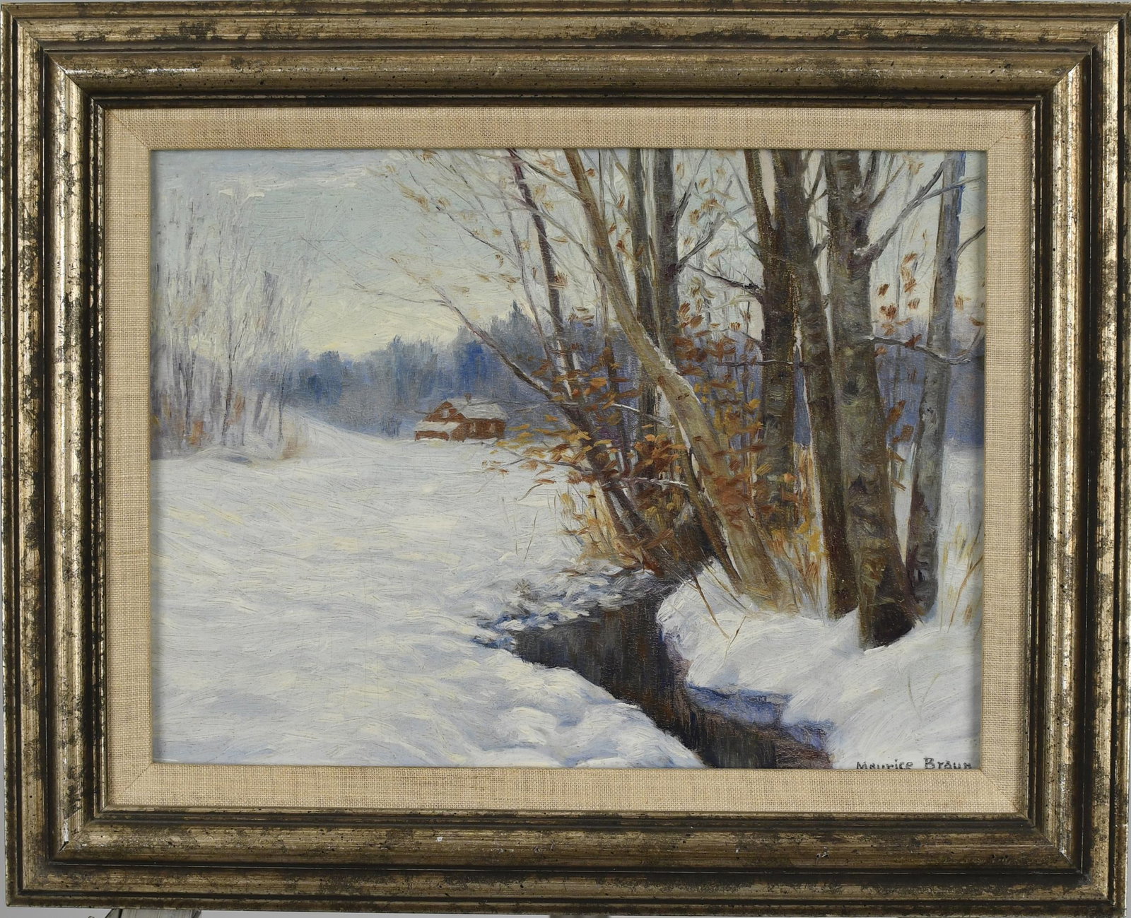 MAURICE BRAUN OIL, WINTER LANDSCAPE.: Maurice Braun (1877 - 1941) oil on paper board, New England winter landscape with a red barn and stream, signed lower right, Maurice Braun. Board 9” x 12”, Overall 12.5” x 15.5”