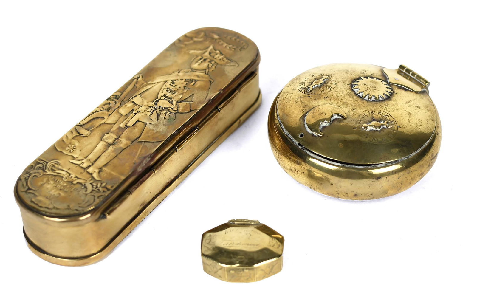 THREE 18TH C. BRASS TOBACCO BOXES.: A long oval Dutch example engraved with Ferdinand, King of Prussia, 6.5'”L, a unique round Dutch example with combination locks and sun and moon, 3.5” dia., and a small French octagonal ex