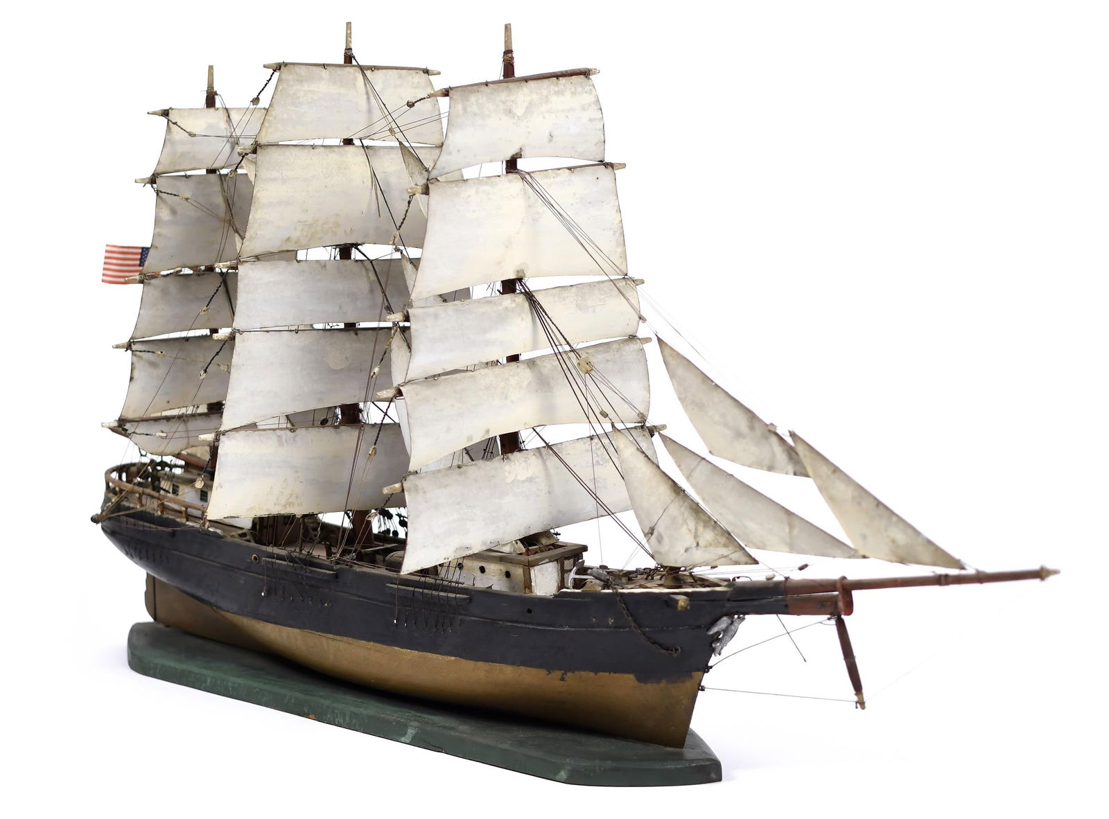 19TH C. SHIP MODEL.: An antique painted wood ship model of an unnamed three-masted bark/ship with wooden sail cloth, 20”H x 33.5”W x 8”D.