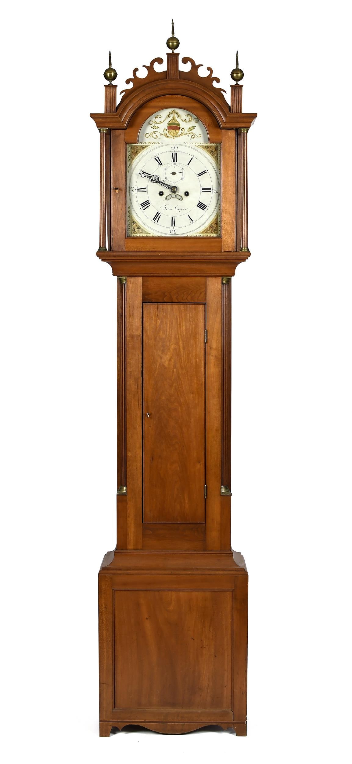 JOHN OSGOOD HAVERHILL NH FEDERAL TALL CLOCK.: Ca. 1800, Federal cherry tall case clock, with a carved crest and fluted pilasters, the case with fluted quarter columns on inlaid cutout base, brass works and painted iron dial signed John Osgood (Ha