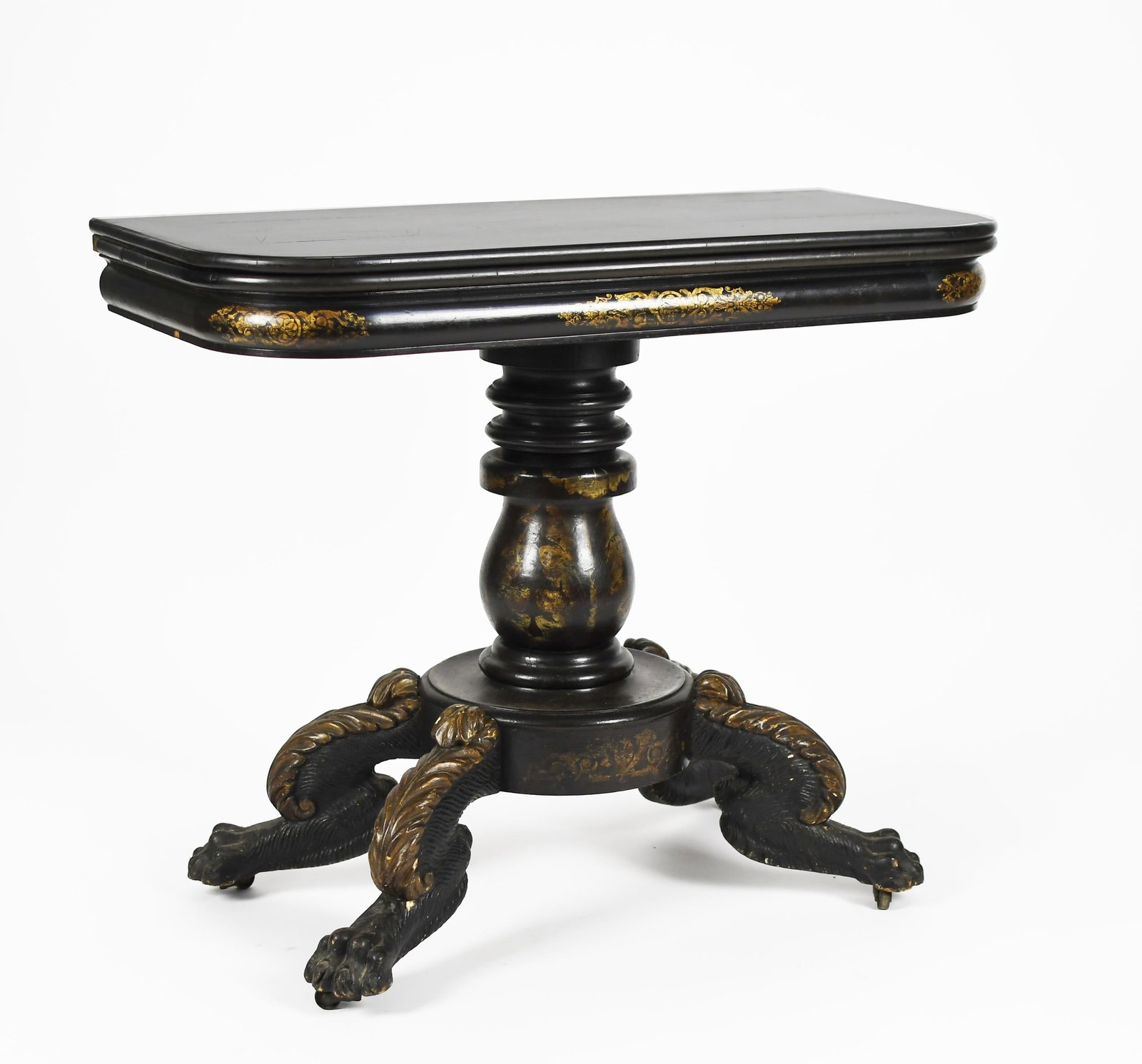 19TH C. CLASSICAL NY PAINT DECORATED GAMES TABLE.: Ca. 1830’s New York games table, with a hinged ebonized (black painted) top and a stencil decorated rolled apron, supported by an elaborately carved and stencil paint decorated pedestal base wit