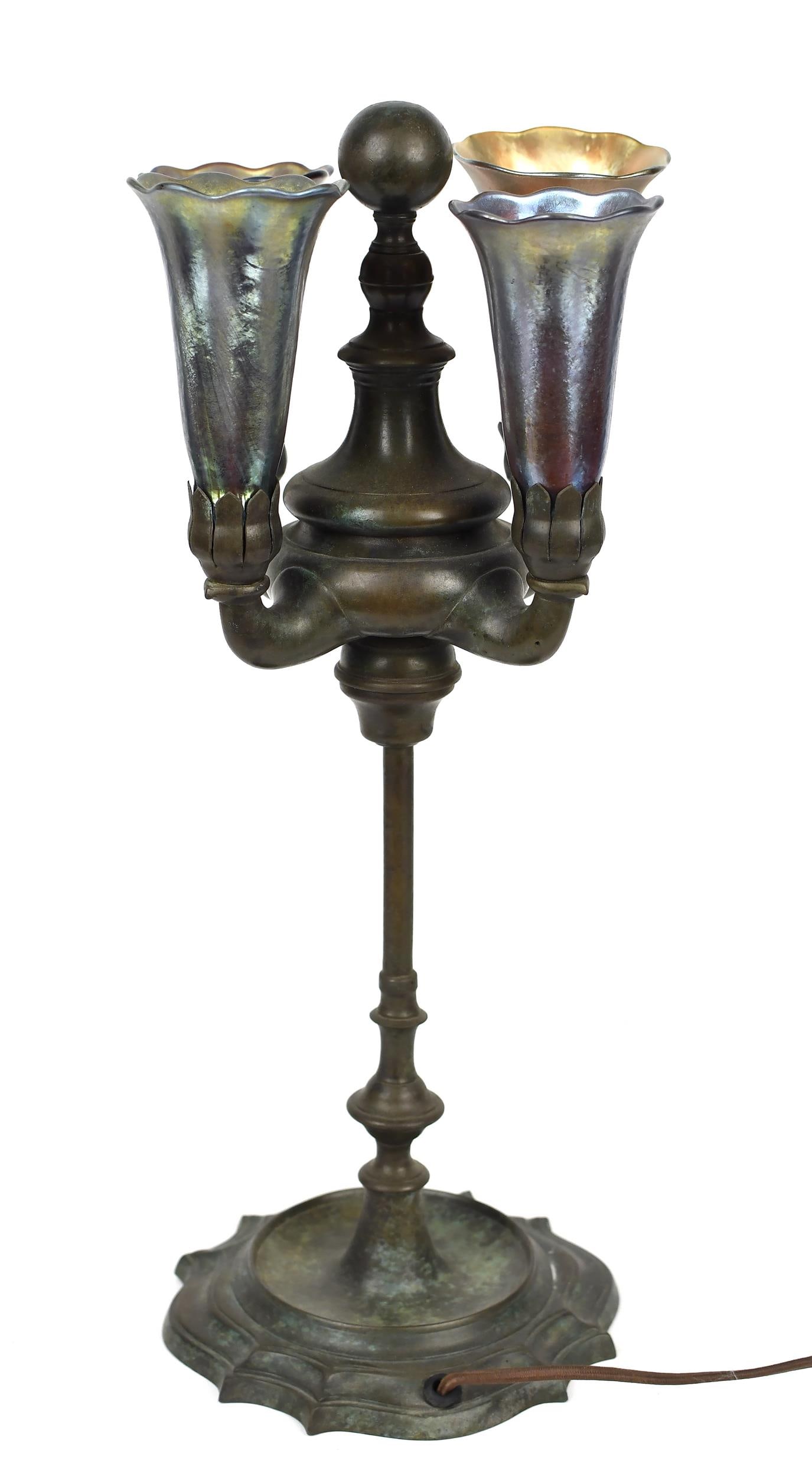 BRONZE TIFFANY LAMP.: A ca. 1900 table lamp, with a bronze base signed Tiffany Studios NY 58770, and four gold favrile shades signed, LCT Favrile. 18”H, shades 4.5”H.
