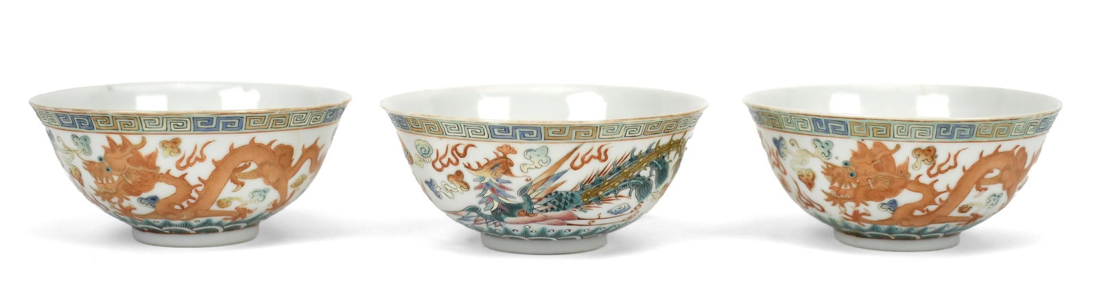 THREE CHINESE PHOENIX AND DRAGON BOWLS.: Three ca. 1900-20 Qing Dynasty Chinese phoenix and dragon bowls with six character orange reign marks, 2”H x 4.75” dia. .