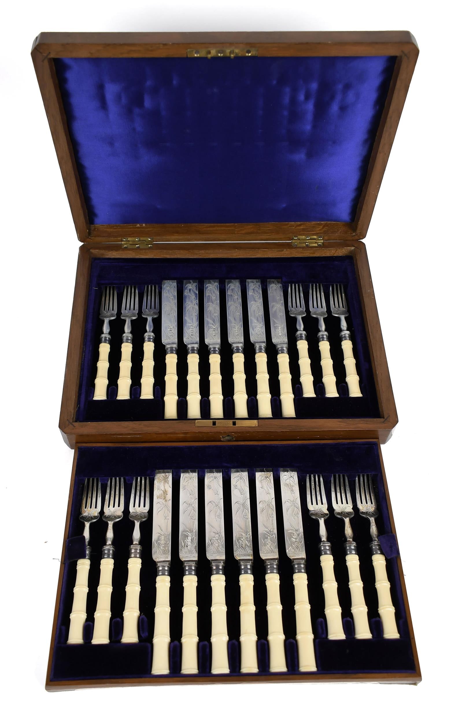 19TH C. JAMES DIXON ENGLISH SILVER CASED FISH SET.: Ca. 1895, a finely presented 24 piece fish set of hallmarked James Dixon & Sons sterling, twelve forks 6.5”L and twelve knives 8”L, all with stylized bamboo bone handles and finely etched 