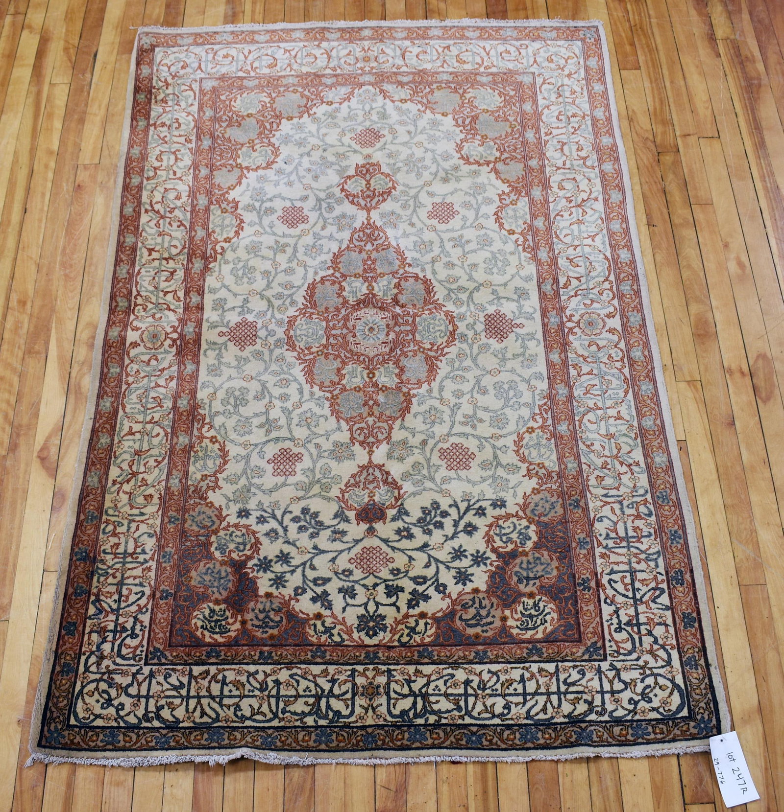 VINTAGE ORIENTAL SCATTER RUG.: Vintage Oriental scatter rug, color faded, with Arabic characters in orange and grey on an ivory ground, 4'5” x 6'10”.