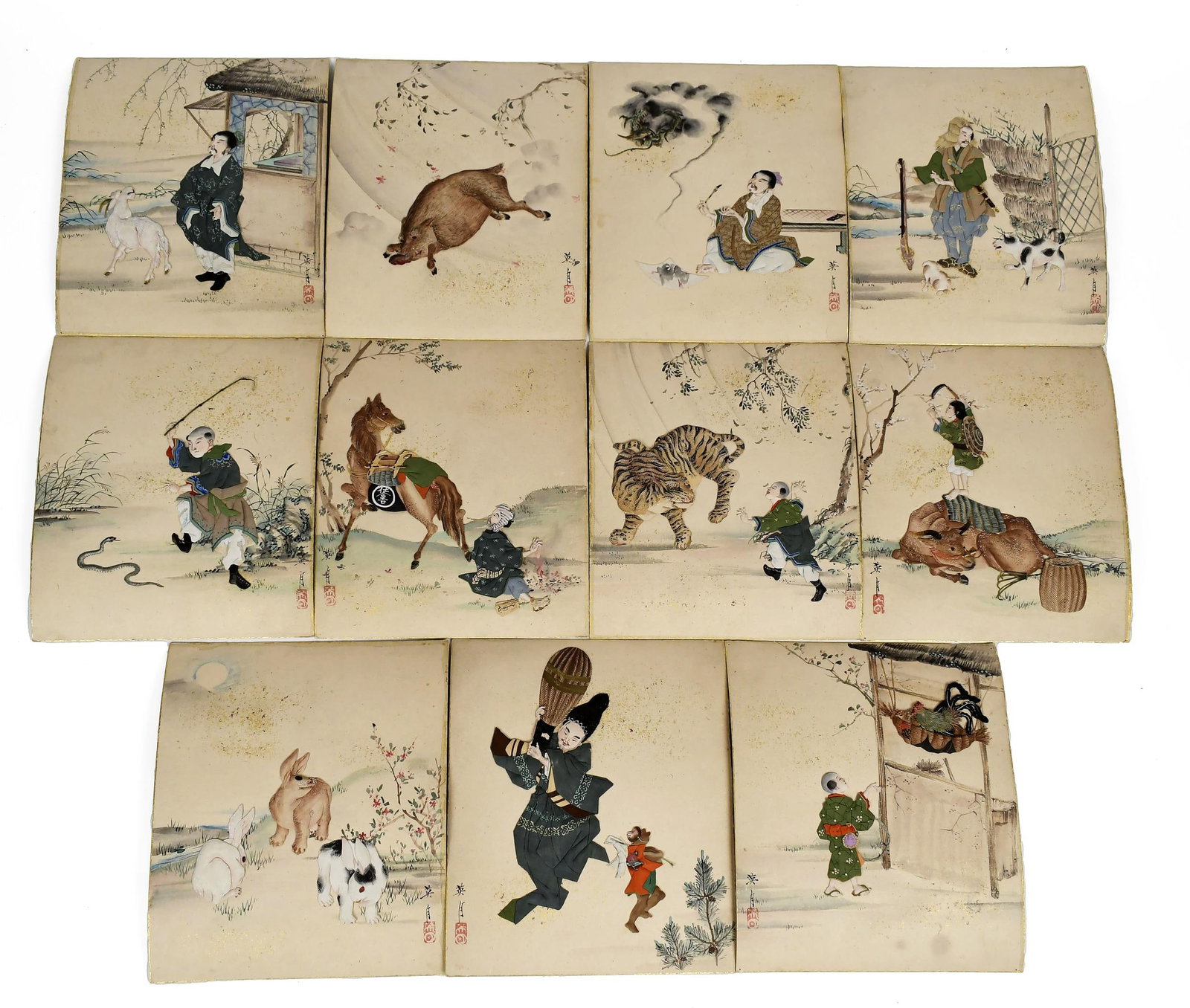 MEIJI JAPANESE RAG PAINTINGS IN BOX.: Set of 11 Japanese 'rag paintings', consisting of folded and cushioned pieces of silk depicting figures, animals and more. On paperboard with watercolor embellishments, in the original wood box, all s