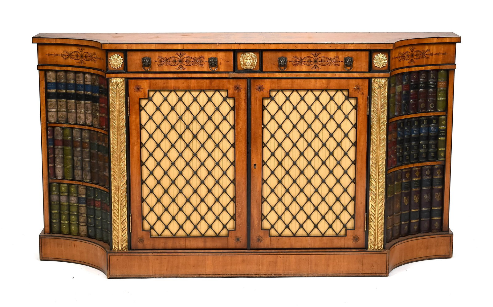 ENGLISH EDWARDIAN SATINWOOD CREDENZA.: Ca. 1900, English stencil decorated and parcel gilt satinwood credenza with book binding ends, and two dovetailed drawers over two doors, with carved and parcel gilt lion head, acanthus columns and ro